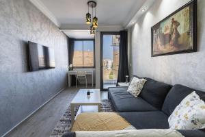 a living room with a couch and a table at Chic Apartment Cosy Stay in Casablanca