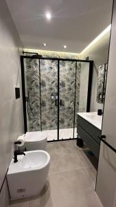 a bathroom with a toilet and a sink and a shower at Stay in Naples in Naples +34 photos