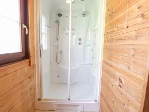 a shower with a glass door in a bathroom at Woodpecker Lodge in Langham +23 photos