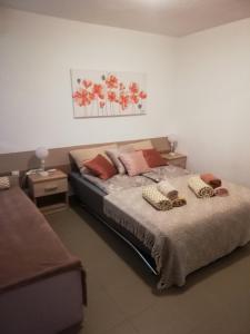 a bedroom with a bed with two pillows on it at Apartman "Vuković" in Bizovac