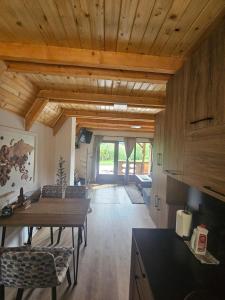 a kitchen with wooden ceilings and a table and chairs at Vikendica IVA in Pale