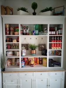 a white pantry cabinet filled with lots of food at Gemütliche 1 Zimmer Ferienwohnung in Ludwigsburg