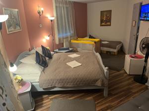 a small bedroom with a bed and a room with at HOTEL Kuruc Panzio TARPA Kossuth utca 25E 