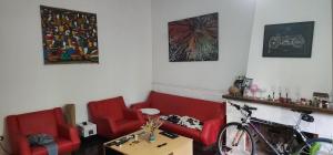 una stanza con sedie rosse, tavolo e bicicletta di @embajadapichincha a Rosario