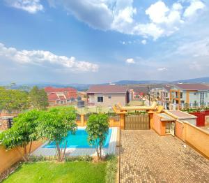 een uitzicht op een zwembad vanuit een appartement bij Luxurious very spacious 6 bedrooms villa with pool located in Gacuriro,close to simba center and a 12mins drive to downtown kigali in Kigali