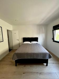 a bedroom with a bed in a white room at Sha Sho in Mostar