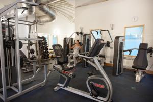 a man in a gym with several tread machines at Apollo Hotel in Basingstoke