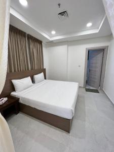 ein Schlafzimmer mit einem großen Bett in einem Zimmer in der Unterkunft برج ماجيك سويت Magic Suite Tower in Kuwait