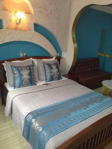 1 dormitorio con 1 cama grande y 1 sofá en CONSTELLATION HOTEL, en Dschang
