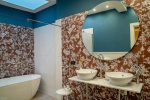 a bathroom with two sinks and a mirror at Hotel Il Guercino in Bologna