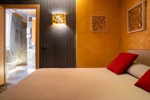 a bedroom with a bed and a light on the wall at Hotel Il Guercino in Bologna