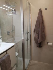 a bathroom with a glass shower and a sink at Casa alla Guitgia 2 in Lampedusa