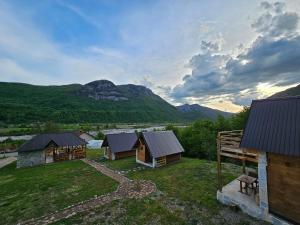 an aerial view of a group of buildings with mountains at Wooden houses Bojovic in Gusinje