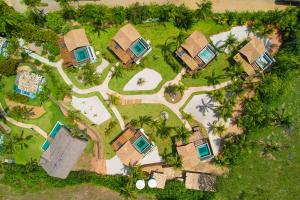 an aerial view of a resort with palm trees at Pousada Reserva do Patacho in Pôrto de Pedras