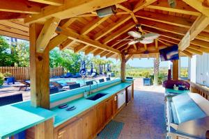 a large outdoor kitchen with a wooden roof at Ziggy's Place in Wilmington