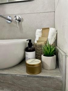 a bathroom with a sink and a bottle of soap at Αura Luxury Apartments in Ierissos