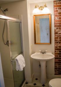 a bathroom with a sink and a shower at High Tide Inn on the Ocean, Motel and Cottages in Camden
