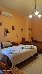 two beds in a room with yellow walls at Casa Holiday Sea Etna Di Enza in Linguaglossa
