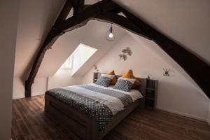 a bedroom with a bed in an attic at Maison rénovée 6 pers, au calme in Oisseau