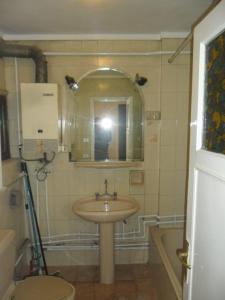 a person taking a picture of a bathroom with a sink at GMR House in Irbid
