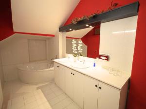 a bathroom with a tub and a sink and a bath tub at City center in Košice