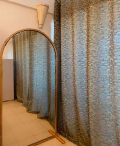 a mirror in a room with some curtains at Samara Studio Apartment - Diani Beachfront in Diani Beach +18 photos