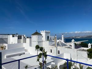 a white building with a view of the ocean at Bab El Fen in Tangier