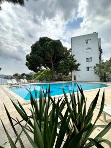 a swimming pool with a building in the background at Kırtay Hotel Erdek in Erdek