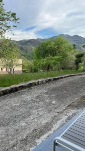 an empty road with trees and mountains in the background at Ca la Trini Vivienda Vacacional in Nava