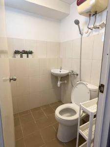 a small bathroom with a toilet and a sink at Modern 2BR Educity Apartment, Pakuwon City in Surabaya