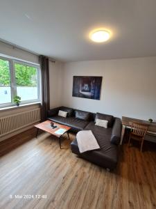 a living room with a couch and a table at Handwerkerwohnung, Monteurunterkunft-Rodgau in Rodgau