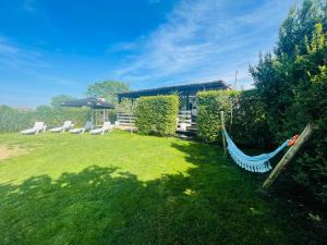 a hammock in the yard of a house at Monte do Bidé Private Farm Peace and Nature in Setúbal