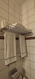 a towel rack in a bathroom with towels on it at Hotel du Roy in Bouillon