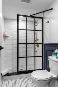 a bathroom with a shower with a toilet in it at King Bed, DTWN Historic Hotel, Fiber Wifi, 50 in Roku TV, Room # 106 in Bangor