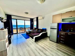 a living room with a couch and a refrigerator at Blue Sunrise Comfort in St. St. Constantine and Helena