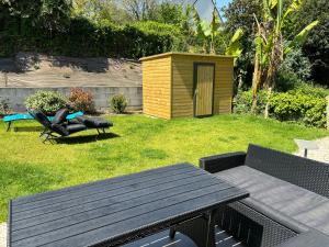 a picnic table and a bench in a yard at Maison spacieuse, centre sarzeau in Sarzeau