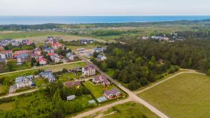 an aerial view of a town with houses and the ocean at Domki CUBA - Komfortowe domki w cichej okolicy in Ostrowo