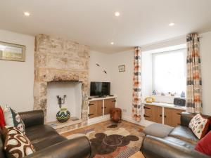 a living room with a couch and a fireplace at Bowman's Cottage in Portland