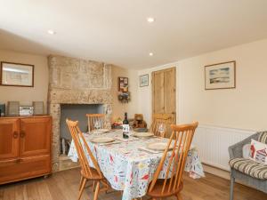 a dining room with a table with chairs and a fireplace at Bowman's Cottage in Portland +24 photos