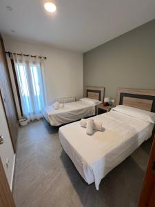 a hotel room with two beds and two windows at Agroestancia Es Peieret in Sant Francesc Xavier