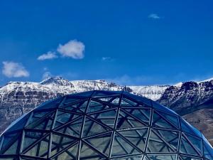 a dome with snow covered mountains in the background at Pure Heart Retreat in Cody