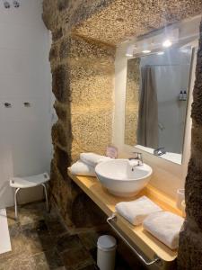 a bathroom with a sink and a mirror at Hotel Pazo de Bieite in Boimorto