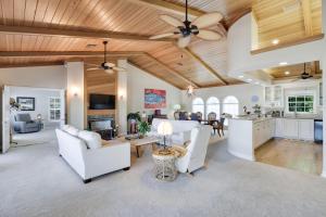 a living room with white furniture and a ceiling fan at Grandma Dot's House- Marina Villa with Pool and Bikes in Sanibel