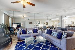 a living room with two couches and a table at Enclave 605 in Orange Beach