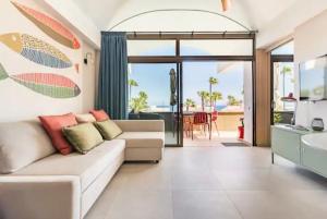 a living room with a couch and a table at Ocean blue 405 in San Bartolomé