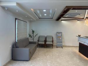 a living room with a couch and two chairs at Hotel Pasupala Inn in Anantapur