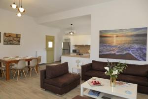 a living room with a couch and a table at Anchorage Andros Villa in Andros