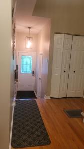 an empty room with a white door and a rug at Private homestay in Kanata South in Ottawa