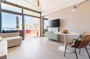 a living room with a couch and a table at Ocean blue 405 in San Bartolomé