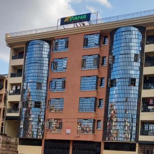 a large building with mirrored windows on top of it at Kahawa sukari luxury home in Nairobi